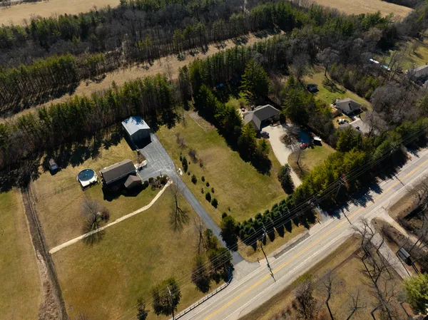 an aerial view of a house with a yard and lake view