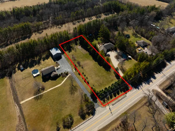 an aerial view of a house with a lake view
