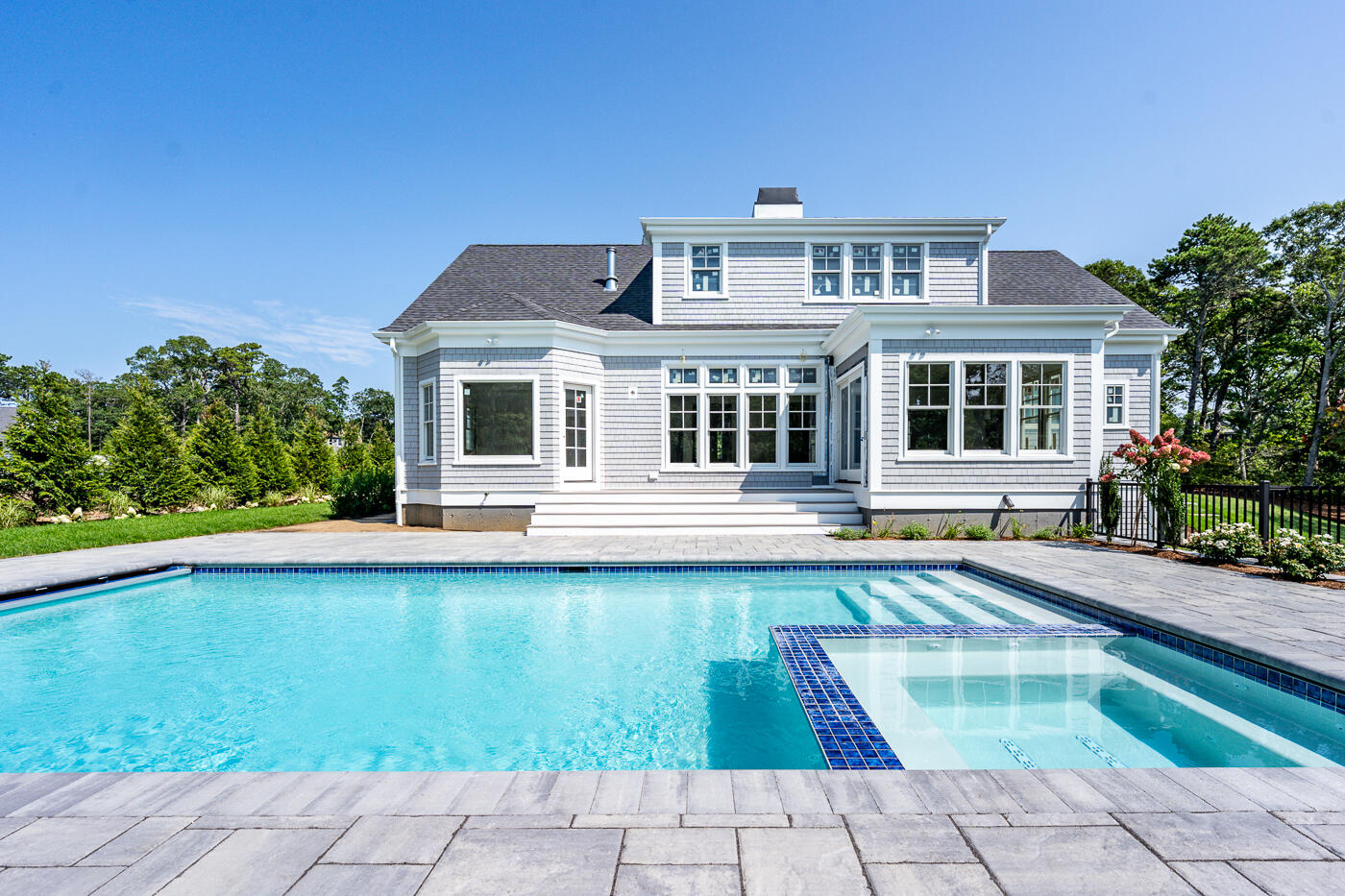 8 Bascom Hollow Harwich, MA 02645 - Photo 2 of 13 a front view of a house with swimming pool