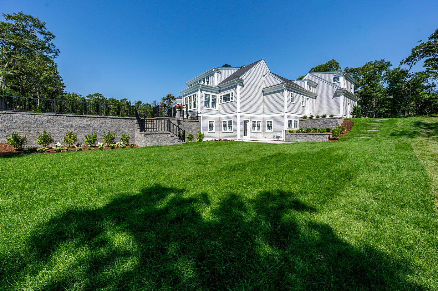 8 Bascom Hollow Harwich, MA 02645 - Photo 4 of 13 a view of a house with a big yard and large trees