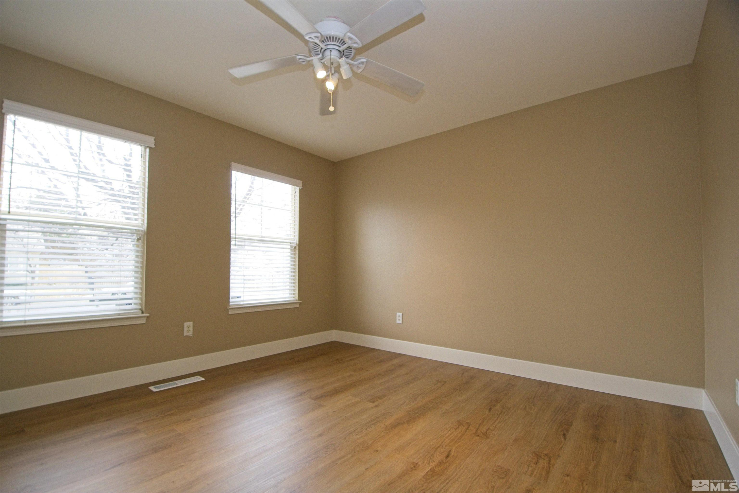 74 River Front Drive Reno, NV 89523 - Photo 16 of 28 a view of an empty room with wooden floor and a window