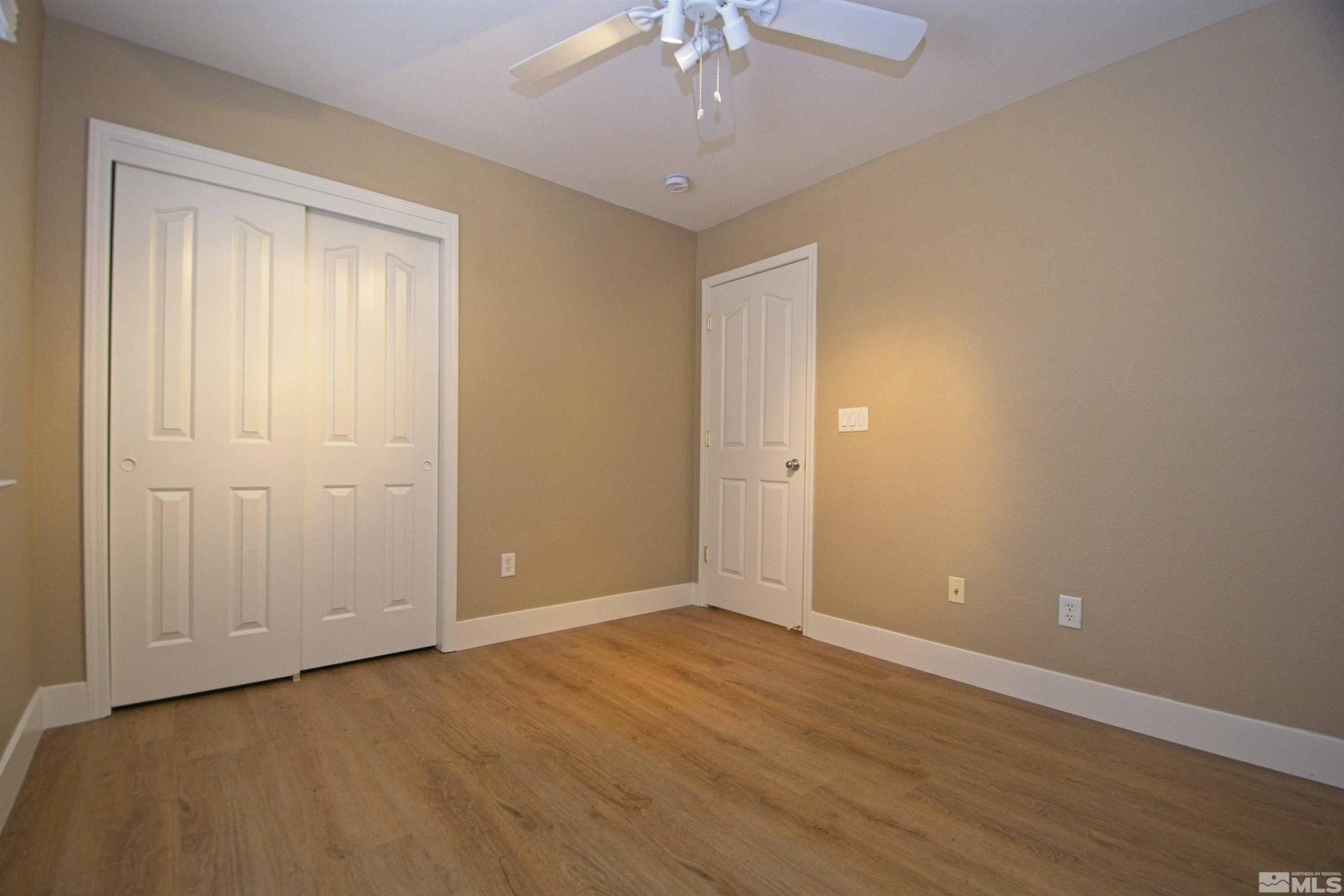 74 River Front Drive Reno, NV 89523 - Photo 20 of 28 a view of an empty room with wooden floor