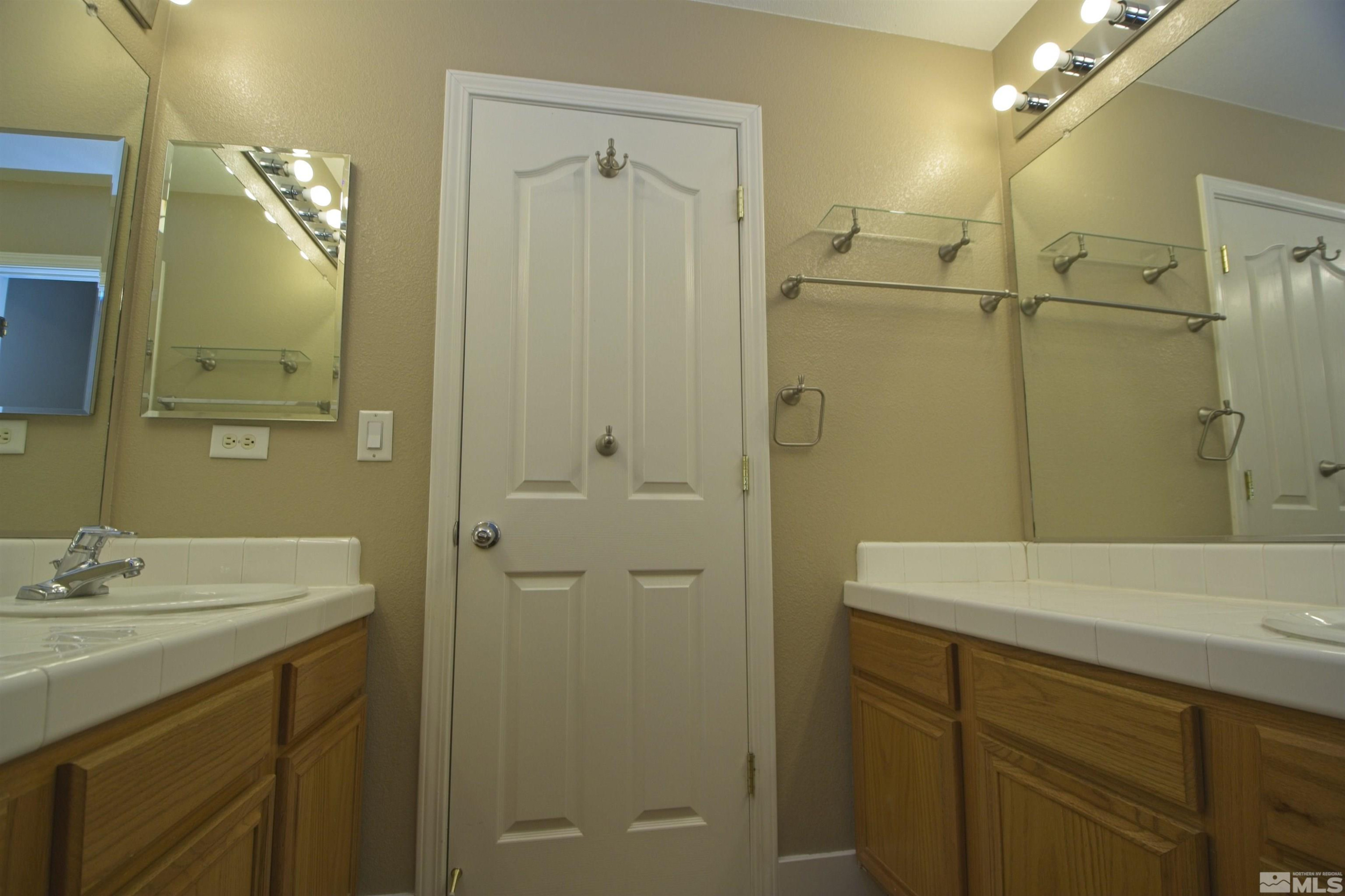 74 River Front Drive Reno, NV 89523 - Photo 21 of 28 a bathroom with a sink shower and a mirror