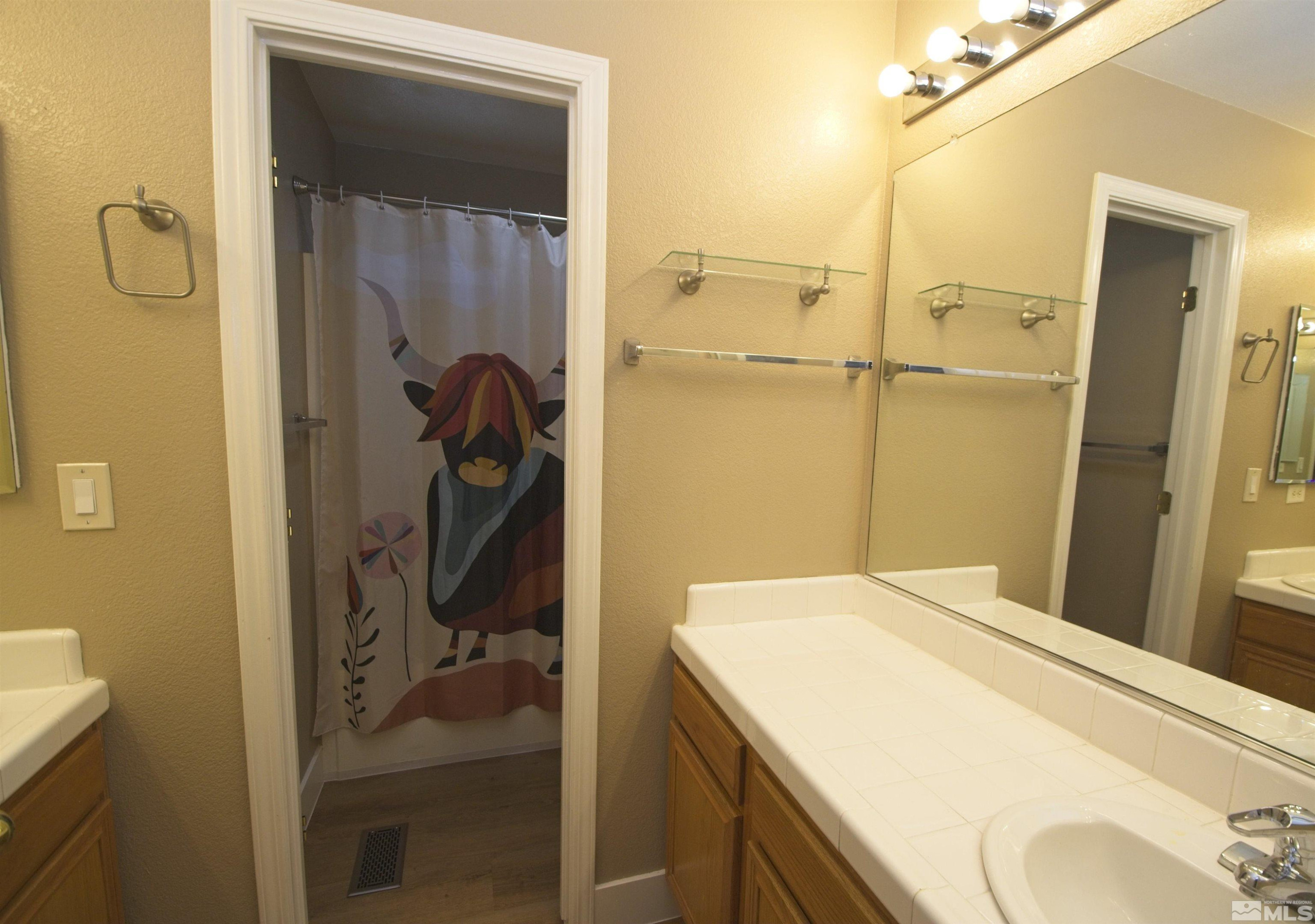 74 River Front Drive Reno, NV 89523 - Photo 22 of 28 a en suite bathroom with a granite countertop sink