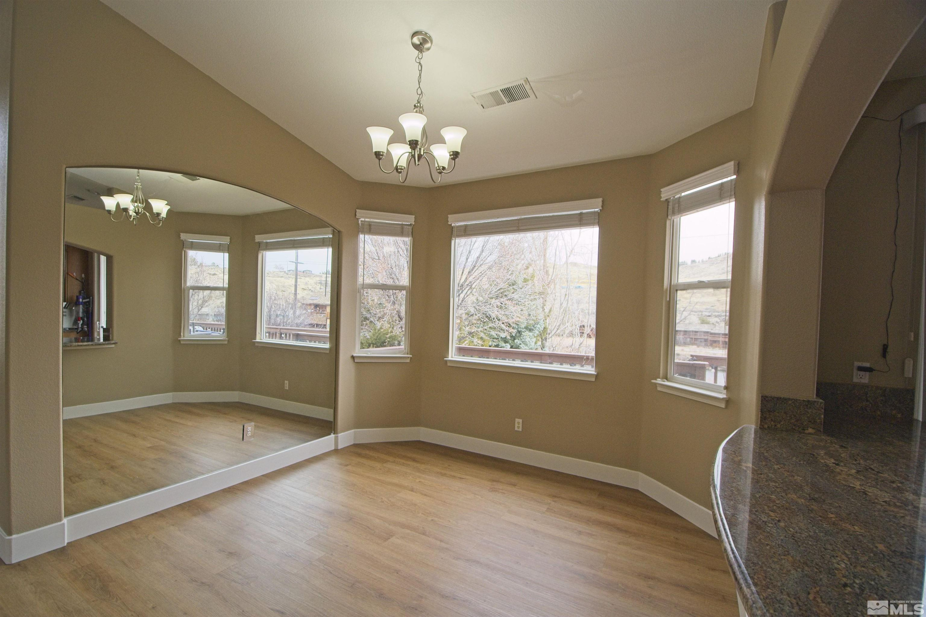 74 River Front Drive Reno, NV 89523 - Photo 5 of 28 a view of an empty room with wooden floor and a window