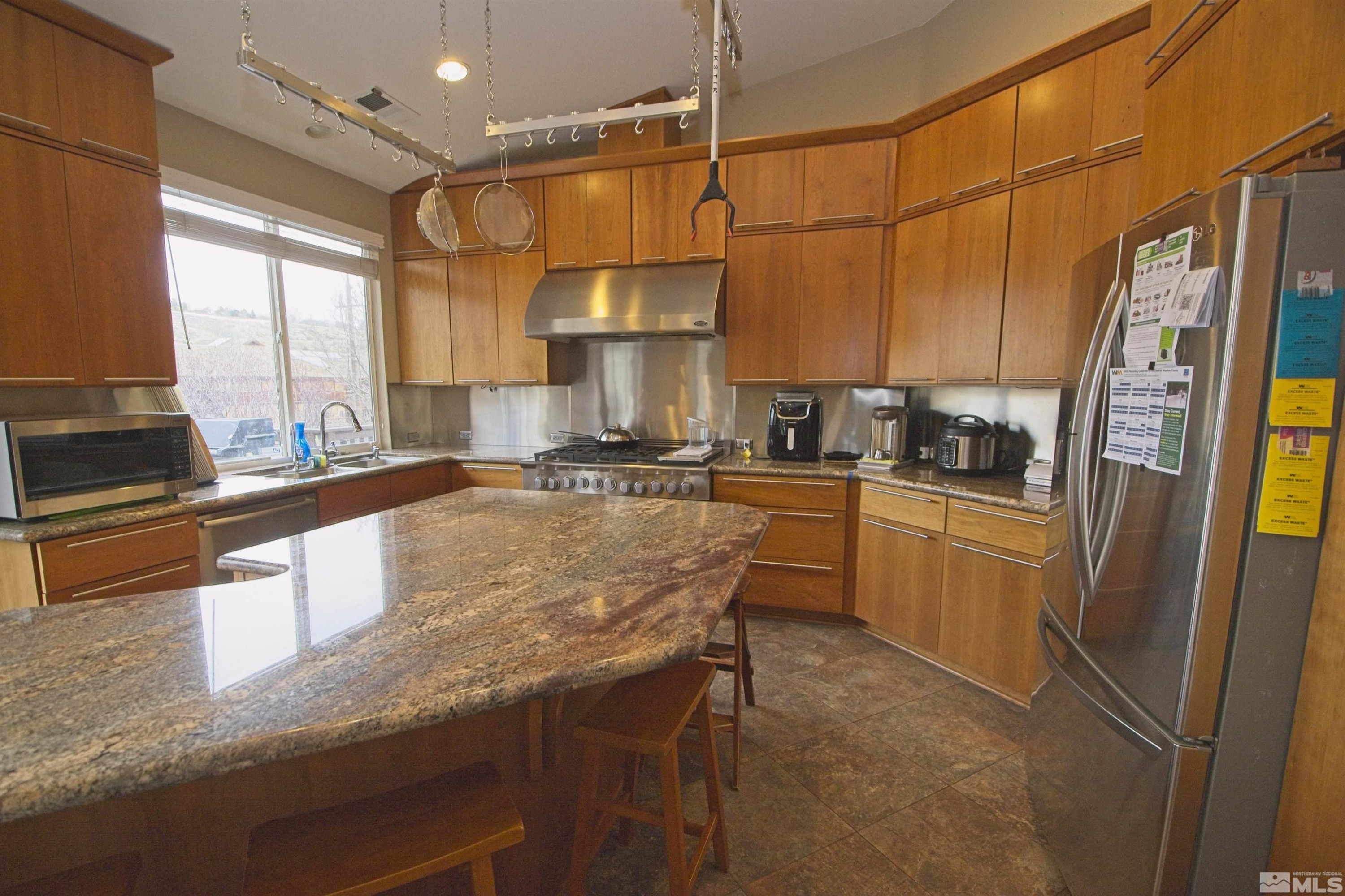 74 River Front Drive Reno, NV 89523 - Photo 8 of 28 a kitchen with granite countertop a sink a counter top space appliances and cabinets