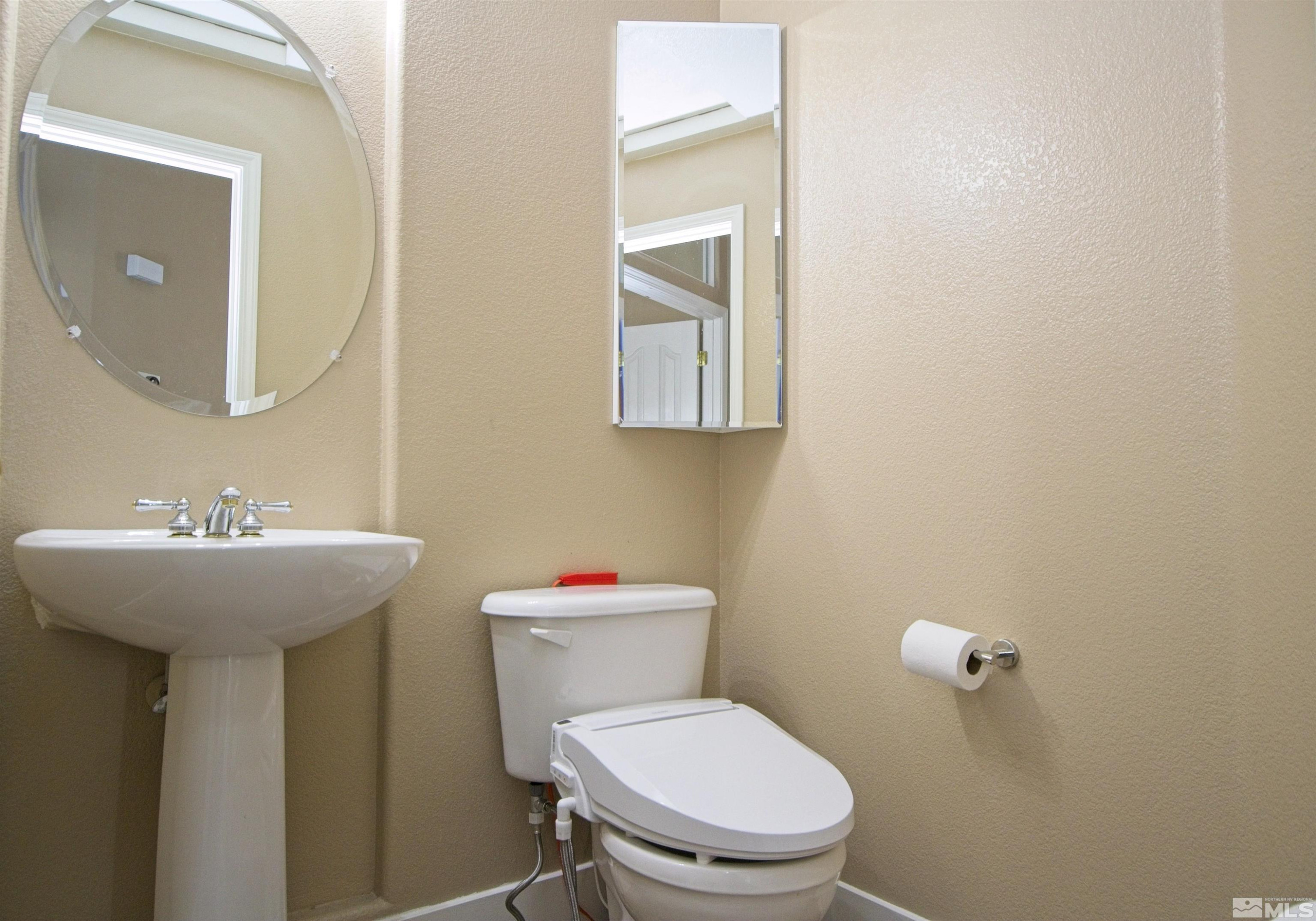 74 River Front Drive Reno, NV 89523 - Photo 9 of 28 a bathroom with a toilet sink and mirror