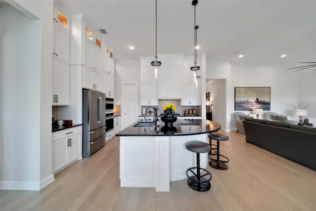 a kitchen with stainless steel appliances granite countertop a stove and a refrigerator