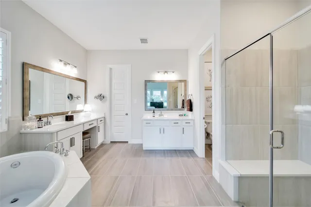 a bathroom with a granite countertop sink mirror and bathtub