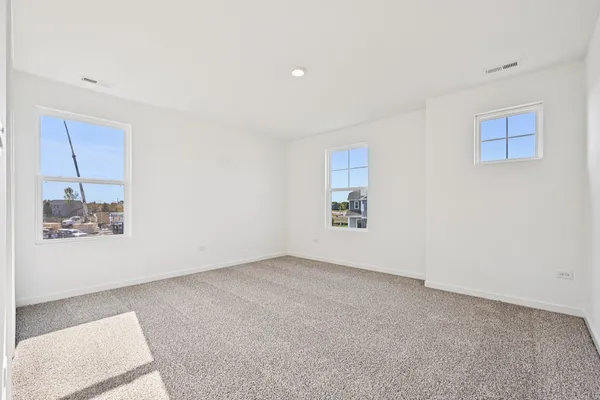 an empty room with a bench and a window