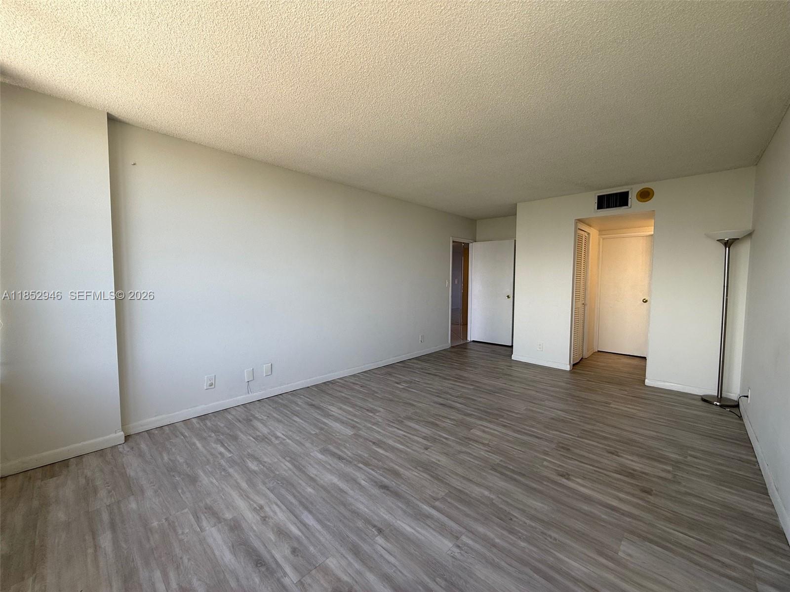 500 Three Islands Boulevard, Unit 715 Hallandale Beach, FL 33009 - Photo 11 of 16 a view of an empty room and wooden floor