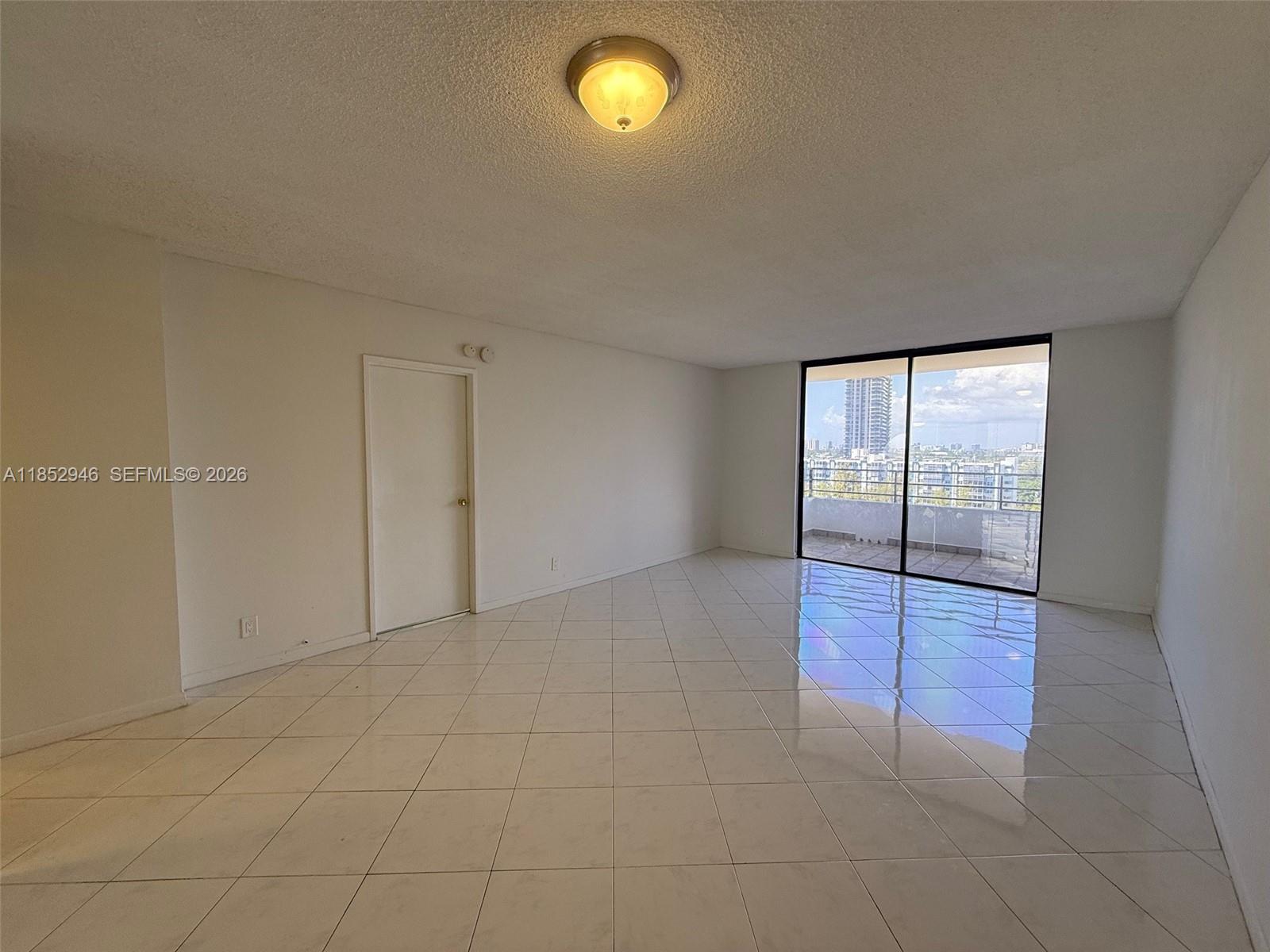 500 Three Islands Boulevard, Unit 715 Hallandale Beach, FL 33009 - Photo 5 of 16 an empty room with fan and window