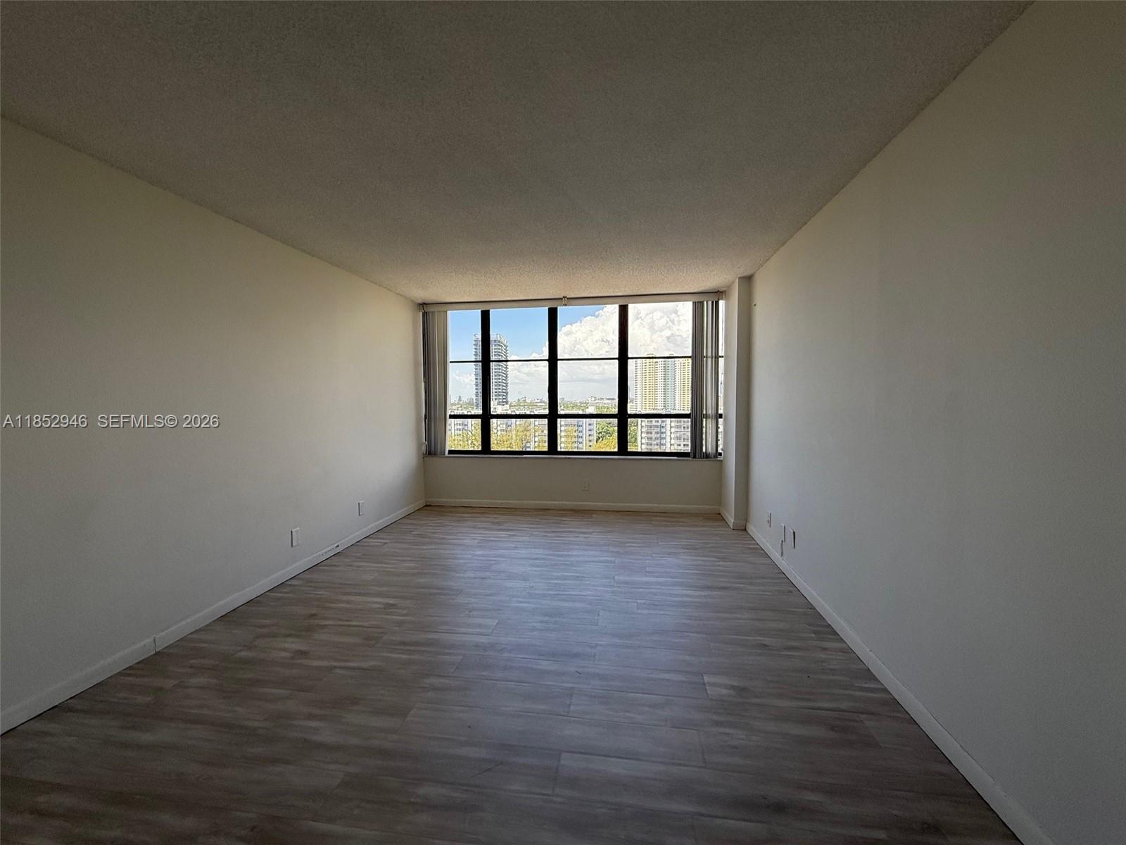500 Three Islands Boulevard, Unit 715 Hallandale Beach, FL 33009 - Photo 9 of 16 wooden floor in an empty room with a window