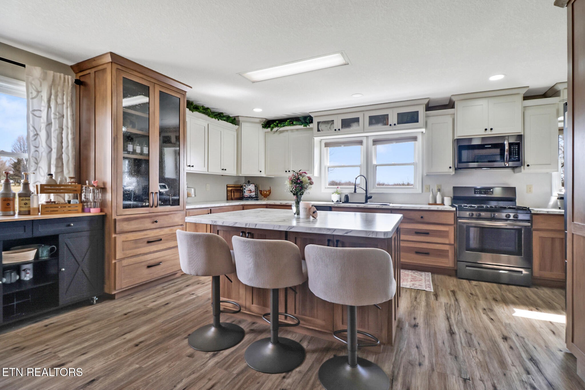 7616 Plateau Road Crossville, TN 38571 - Photo 9 of 60 a kitchen with a table chairs microwave and cabinets