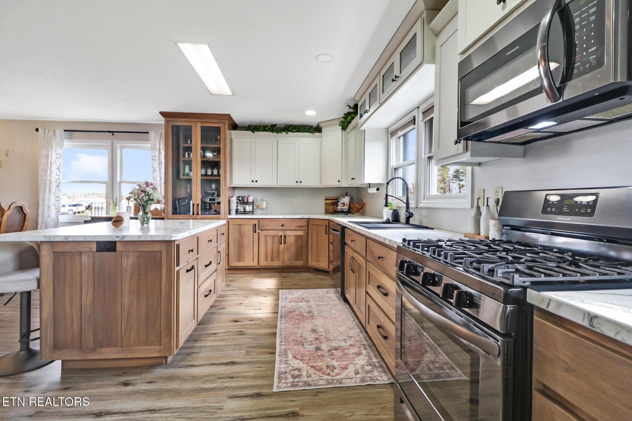 7616 Plateau Road Crossville, TN 38571 - Photo 10 of 60 a large kitchen with stainless steel appliances granite countertop a stove a sink dishwasher and cabinets with wooden floor