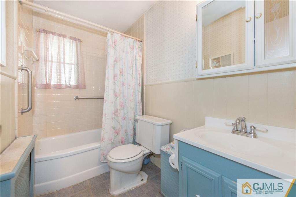 8 Baxter Road Edison, NJ 08817 - Photo 12 of 18 a bathroom with a sink toilet and shower