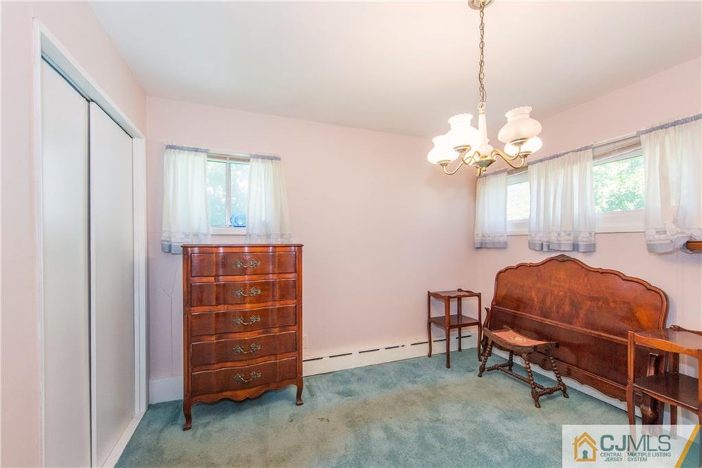 8 Baxter Road Edison, NJ 08817 - Photo 13 of 18 a living room with furniture and a chandelier