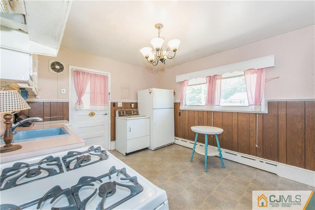 8 Baxter Road Edison, NJ 08817 - Photo 6 of 18 a living room with furniture and a chandelier