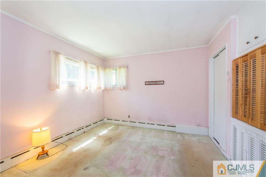 8 Baxter Road Edison, NJ 08817 - Photo 10 of 18 a view of a livingroom with an empty space and a window