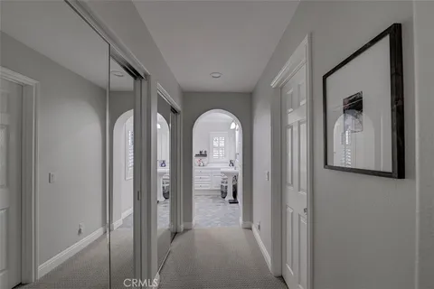 a view of a hallway with wooden floor and glass door