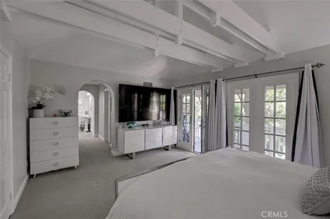 a bedroom with a large bed and a large window