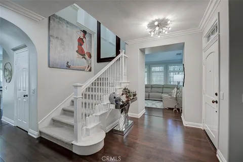 a view of entryway and hall with wooden floor