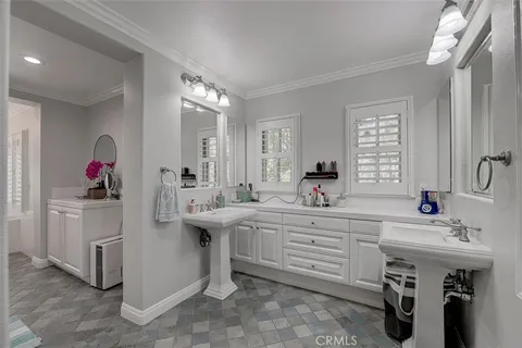 a spacious bathroom with a sink and a mirror