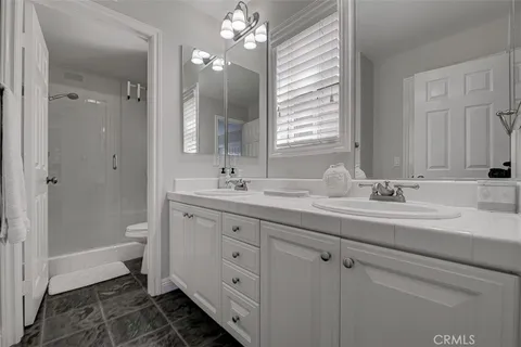 a bathroom with a double vanity sink and a mirror