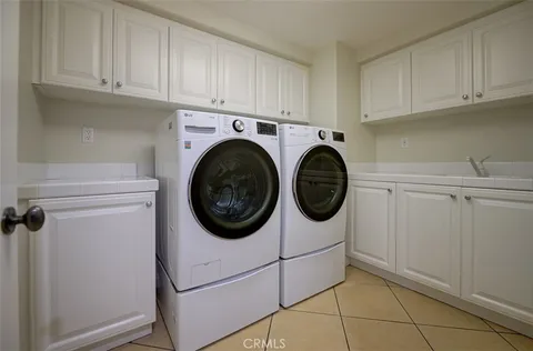 a view of a kitchen with white cabinets