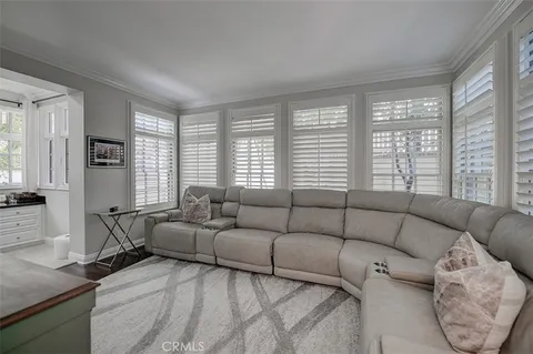 a living room with furniture and large windows