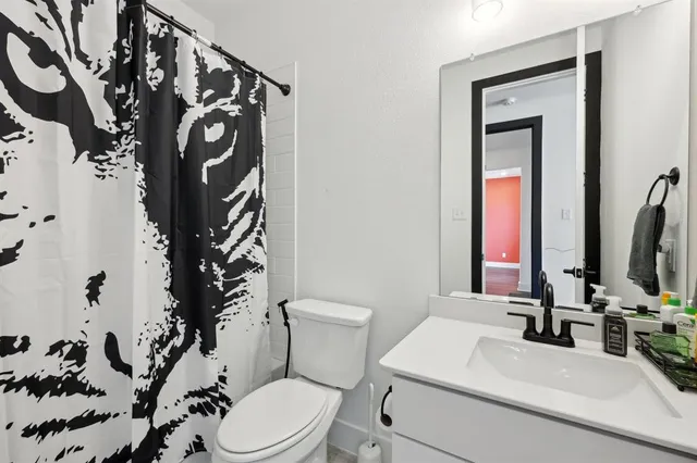 a bathroom with a toilet sink and mirror