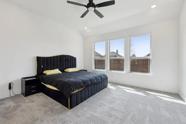 a bedroom with a bed lamp and window