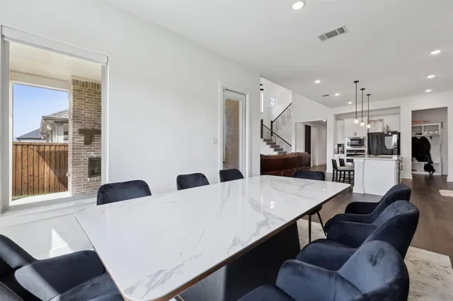 a living room with stainless steel appliances kitchen island granite countertop furniture and a view of kitchen