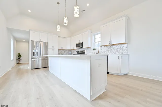 a balcony of a house with wooden floor outdoor seating and yard in the back