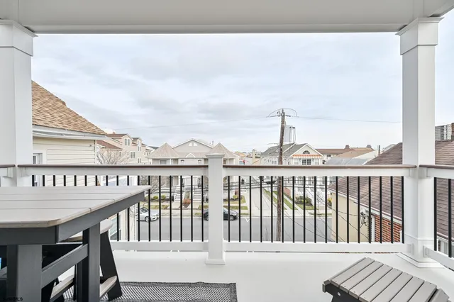a view of hallway with window and wooden floor