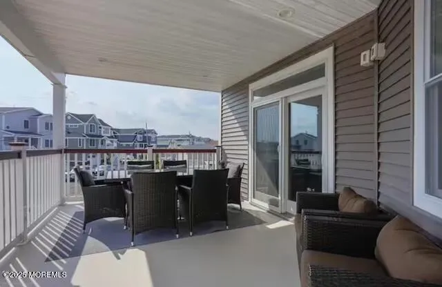 a balcony with furniture and a potted plant