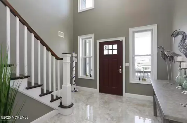 a view of an entryway with wooden floor and door