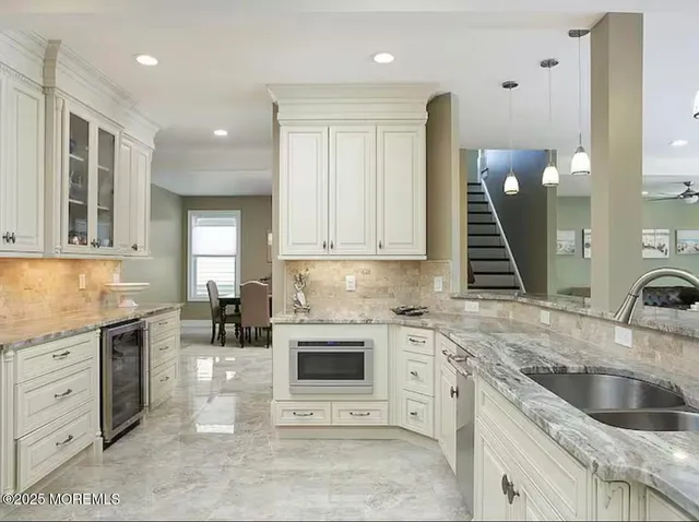a kitchen with a sink cabinets and window