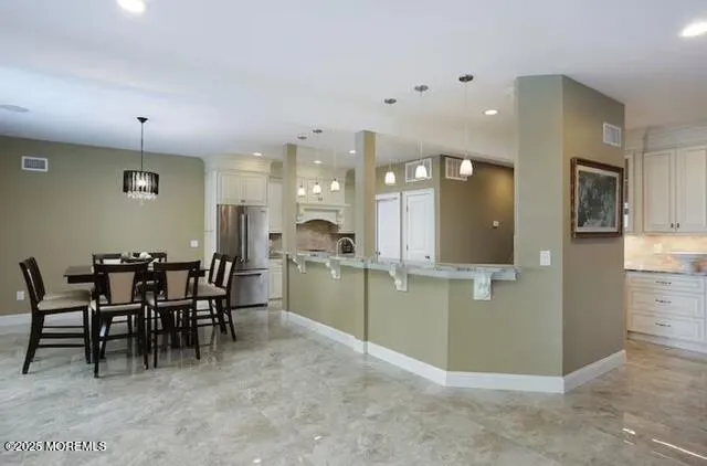a view of a kitchen and dining room