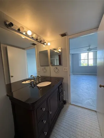 a bathroom with a sink double vanity and a mirror