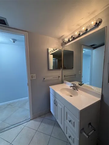 a bathroom with a sink a mirror and a toilet