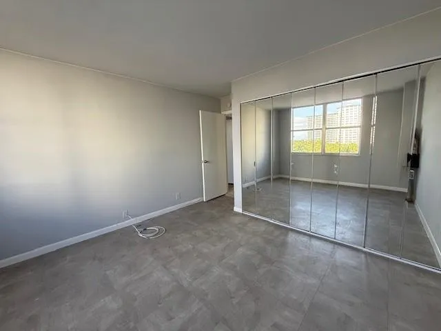 an empty room with a empty space and windows