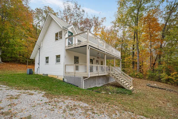 a view of house with a yard