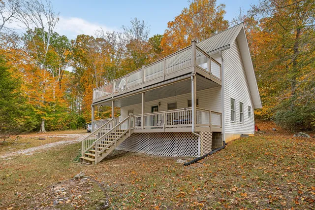 a living room with furniture and large windows