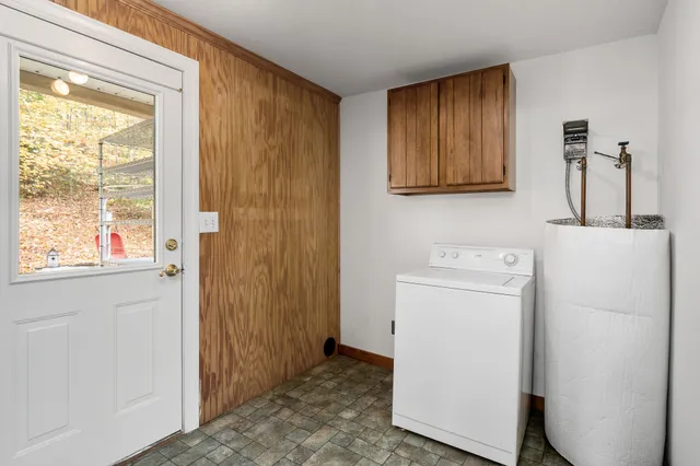 a living room with furniture ceiling fan and a large window