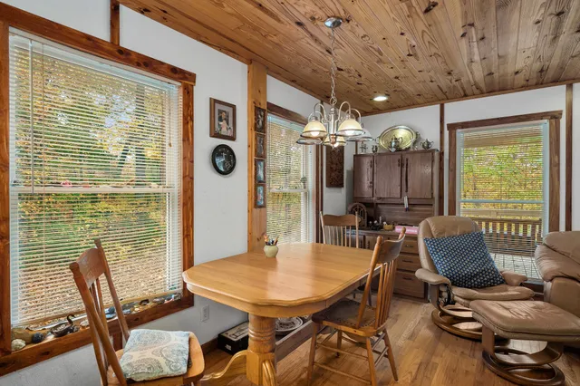 a kitchen with granite countertop a sink window and cabinets