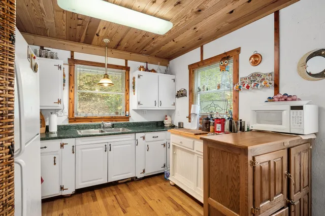 a white refrigerator freezer sitting inside of a kitchen