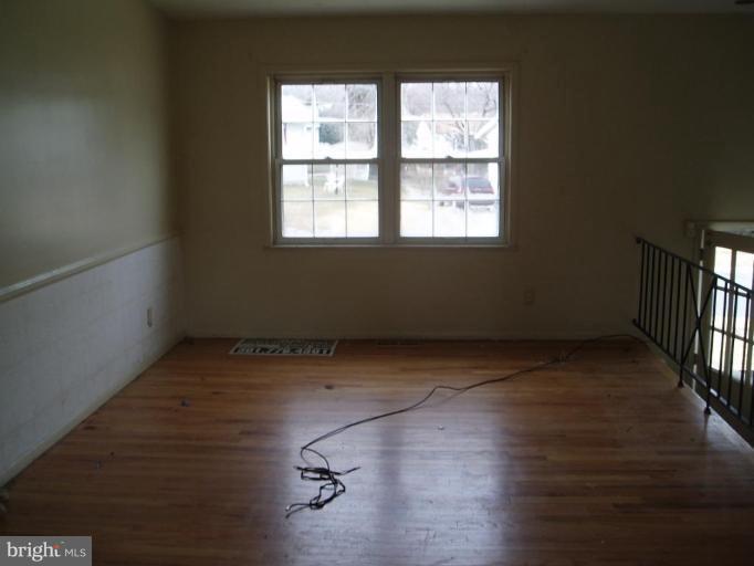 620 Banyan Road Edgewood, MD 21040 - Photo 4 of 15 an empty room with wooden floor and windows