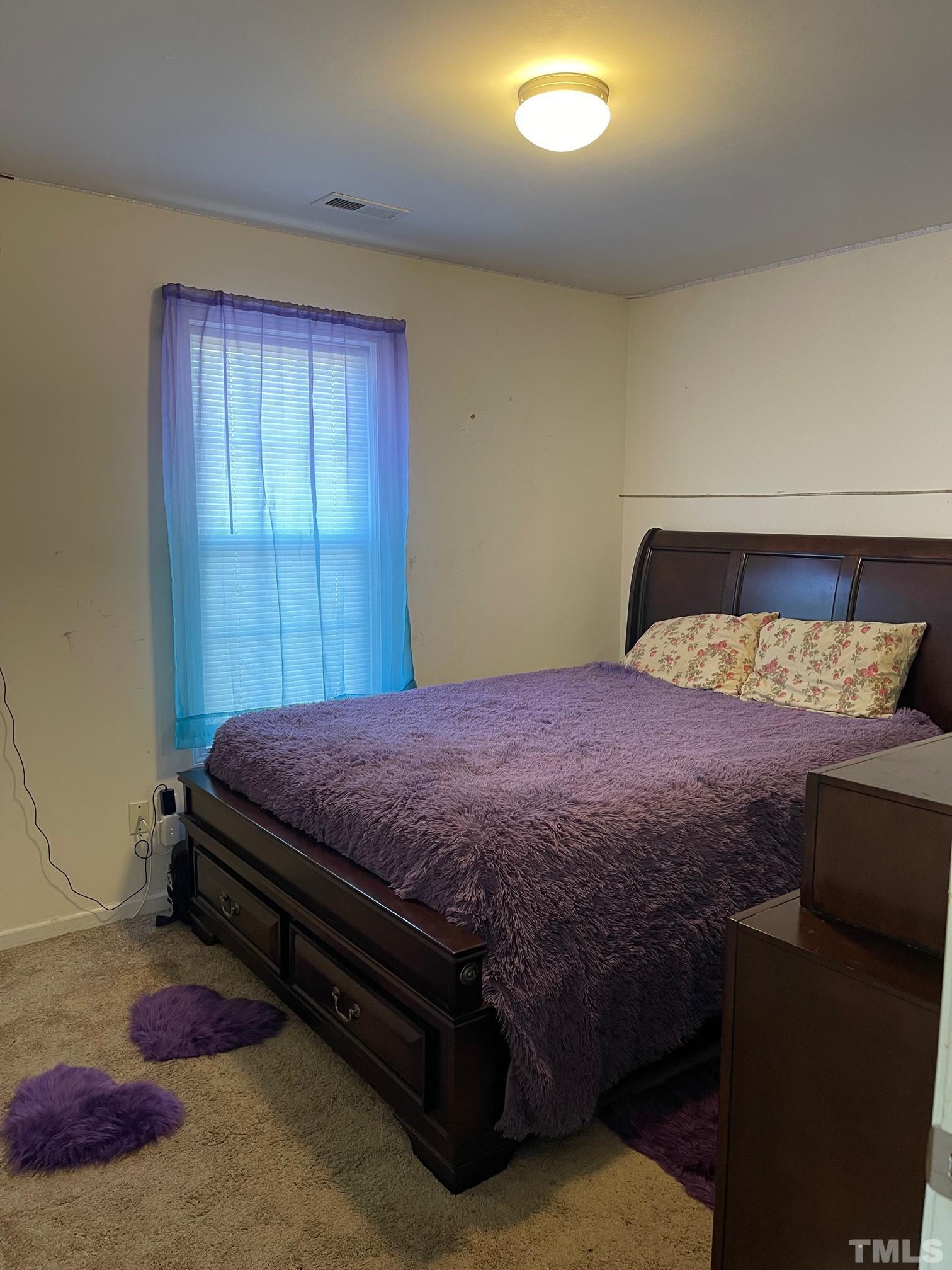 3516 Rendition Street Raleigh, NC 27610 - Photo 17 of 24 a bedroom with a bed and a cabinets