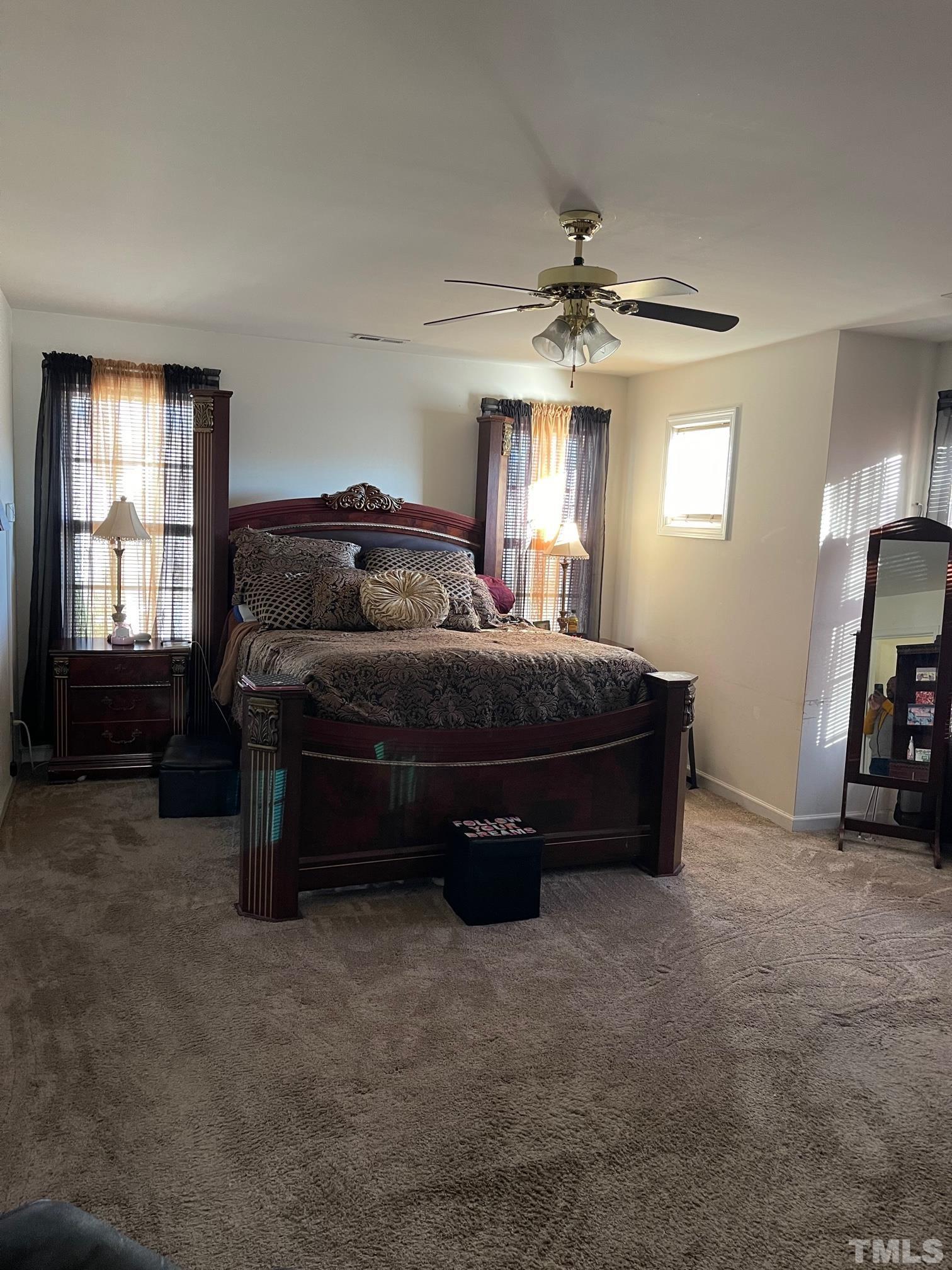 3516 Rendition Street Raleigh, NC 27610 - Photo 19 of 24 a bedroom with a bed and a chandelier